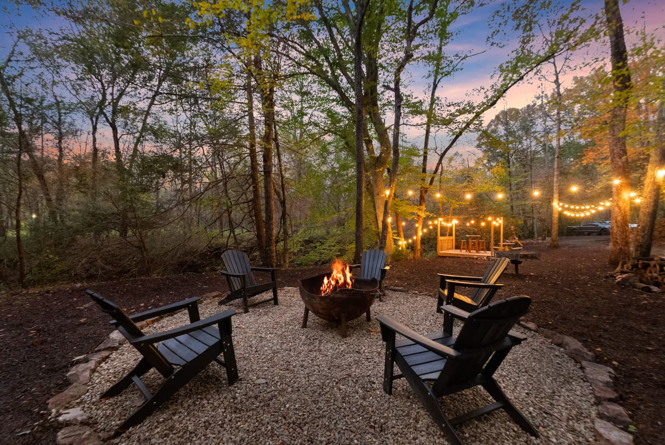 Fire pit with Adirondack chairs at dusk