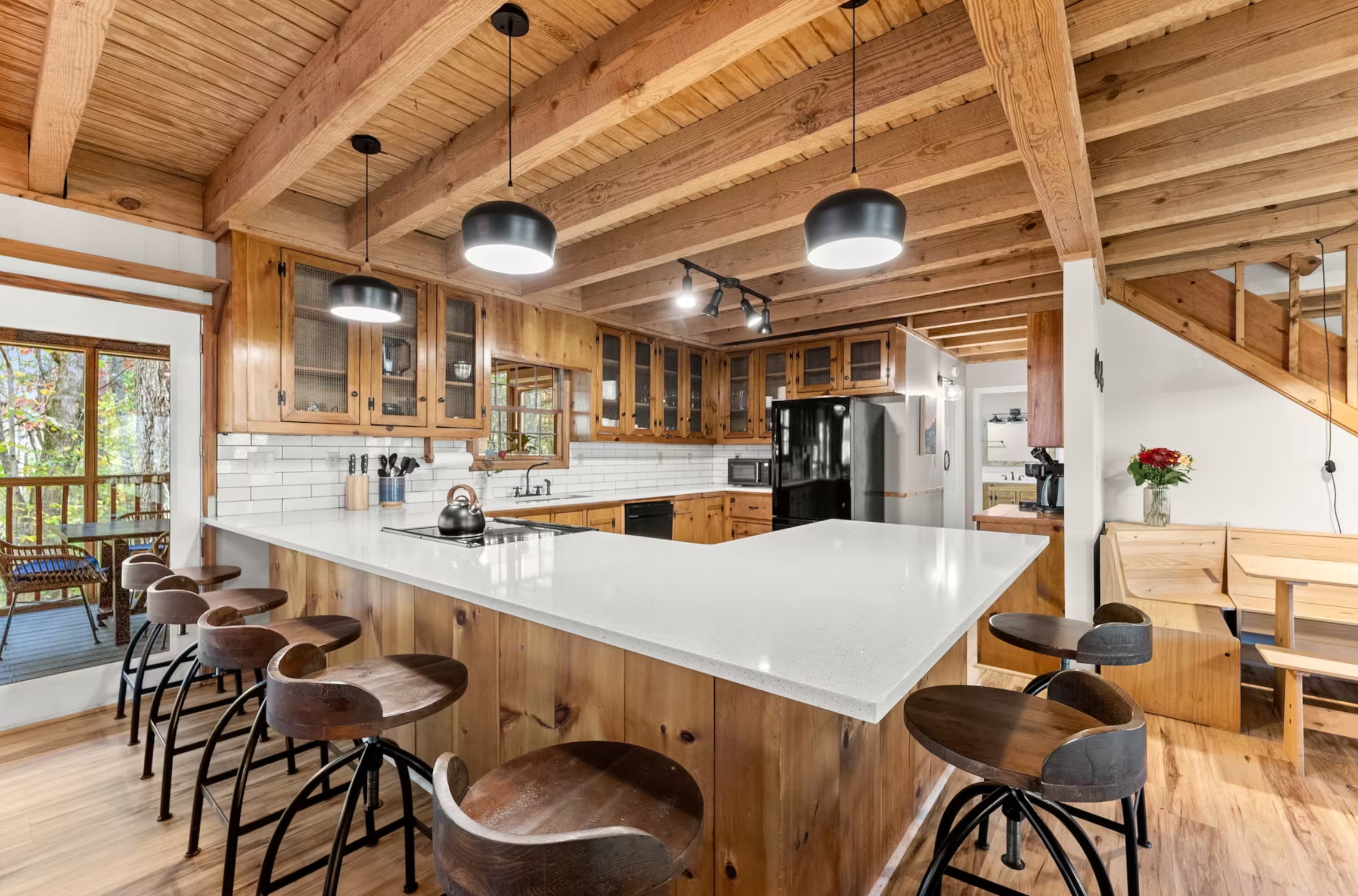 Open kitchen with island and wooden beams